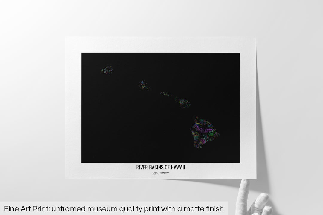 Unframed fine art print of a colourful map with a thick white mat. The title of the map and the Grasshopper Geography logo is printed on the mat, below the image. The map print lies flat on a white surface, a hand holding up one of the corners. The bottom text reads: Fine art print - unframed museum quality print with a matte finish.