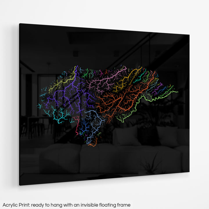 A colourful Grasshopper Geography map hanging on a white wall. The text at the bottom reads: Acrylic print - ready to hang with an invisible floating frame.