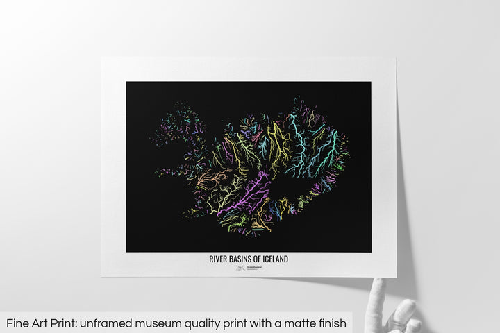 Unframed fine art print of a colourful map with a thick white mat. The title of the map and the Grasshopper Geography logo is printed on the mat, below the image. The map print lies flat on a white surface, a hand holding up one of the corners. The bottom text reads: Fine art print - unframed museum quality print with a matte finish.