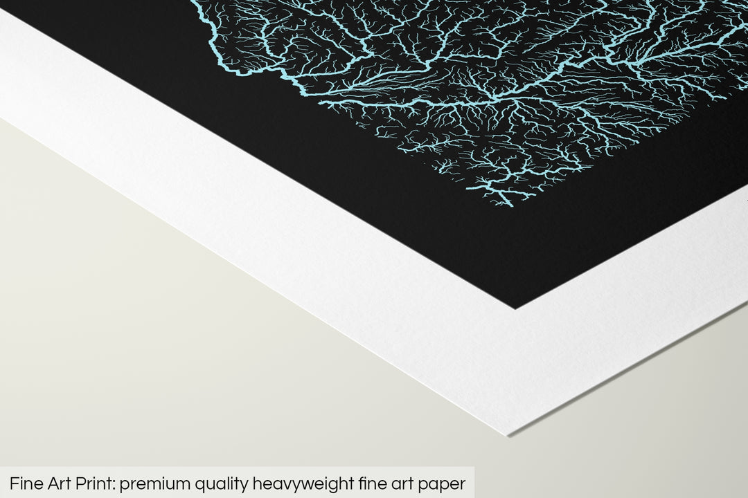 Closeup of a fine art print's corner lying on a flat surface, the details of a Grasshopper Geography map is visible. The text at the bottom reads: Fine art print - premium quality heavyweight fine art paper.