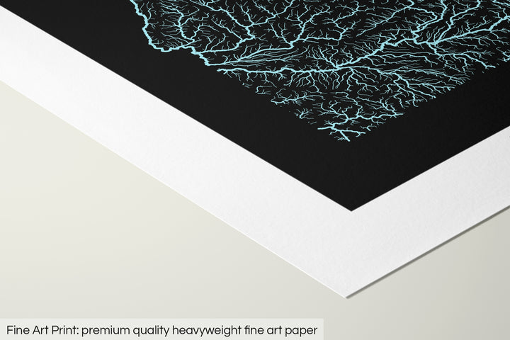 Closeup of a fine art print's corner lying on a flat surface, the details of a Grasshopper Geography map is visible. The text at the bottom reads: Fine art print - premium quality heavyweight fine art paper.
