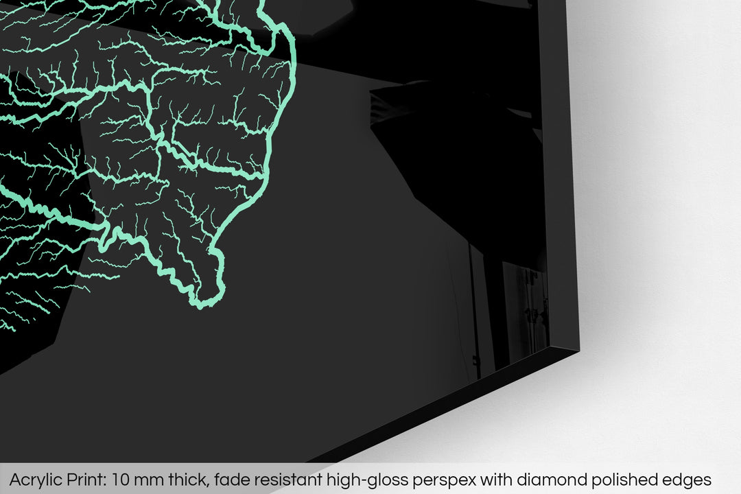 Closeup of an acrylic panel's corner, the details of a Grasshopper Geography map is visible. The text at the bottom reads: Acrylic print - 10 mm thick, fade reistant high-gloss perspex with diamond polished edges.