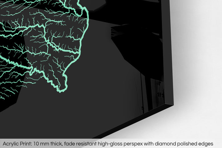 Closeup of an acrylic panel's corner, the details of a Grasshopper Geography map is visible. The text at the bottom reads: Acrylic print - 10 mm thick, fade reistant high-gloss perspex with diamond polished edges.