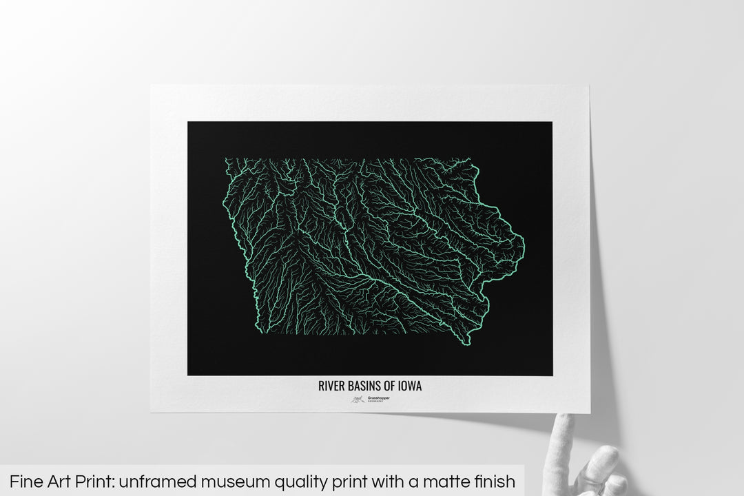 Unframed fine art print of a colourful map with a thick white mat. The title of the map and the Grasshopper Geography logo is printed on the mat, below the image. The map print lies flat on a white surface, a hand holding up one of the corners. The bottom text reads: Fine art print - unframed museum quality print with a matte finish.