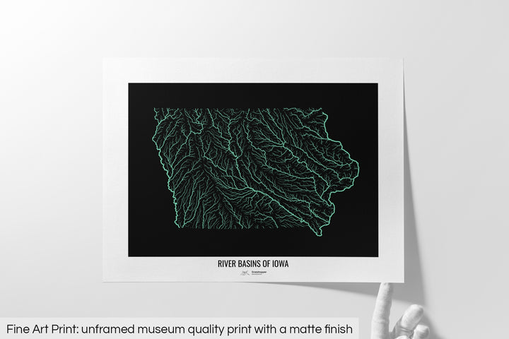Unframed fine art print of a colourful map with a thick white mat. The title of the map and the Grasshopper Geography logo is printed on the mat, below the image. The map print lies flat on a white surface, a hand holding up one of the corners. The bottom text reads: Fine art print - unframed museum quality print with a matte finish.