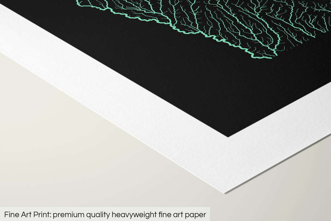 Closeup of a fine art print's corner lying on a flat surface, the details of a Grasshopper Geography map is visible. The text at the bottom reads: Fine art print - premium quality heavyweight fine art paper.