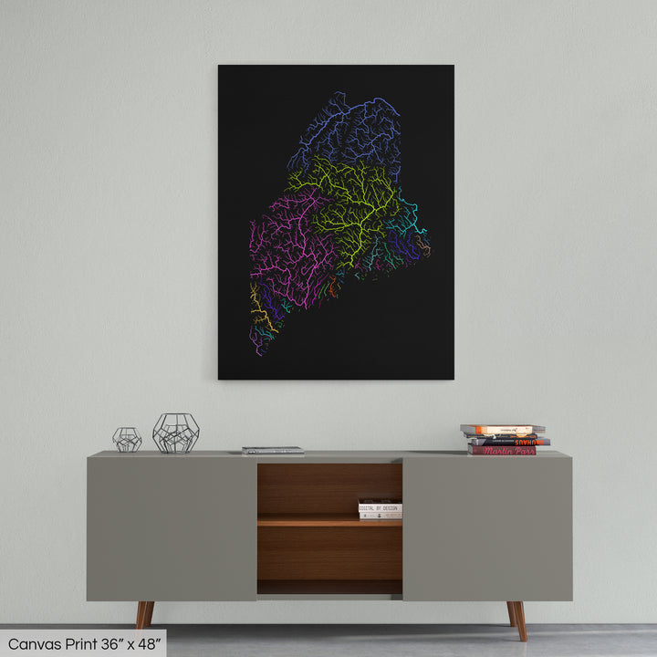 A colourful Grasshopper Geography map home decor in a living room, on a light grey wall. The map is printed on canvas and hangs above a modern low storage cabinet.