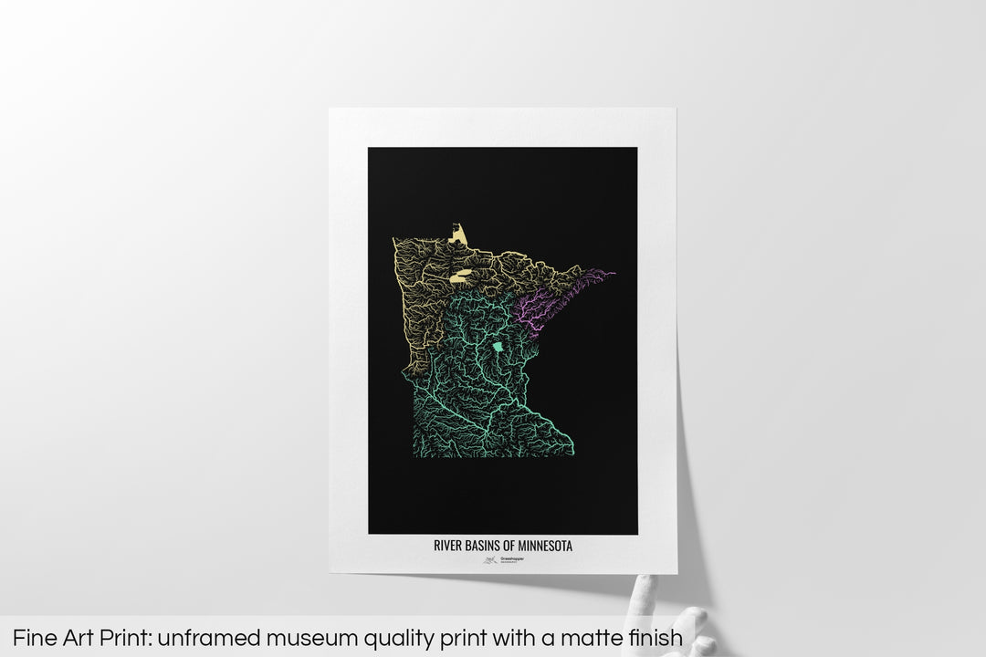 Unframed fine art print of a colourful map with a thick white mat. The title of the map and the Grasshopper Geography logo is printed on the mat, below the image. The map print lies flat on a white surface, a hand holding up one of the corners. The bottom text reads: Fine art print - unframed museum quality print with a matte finish.