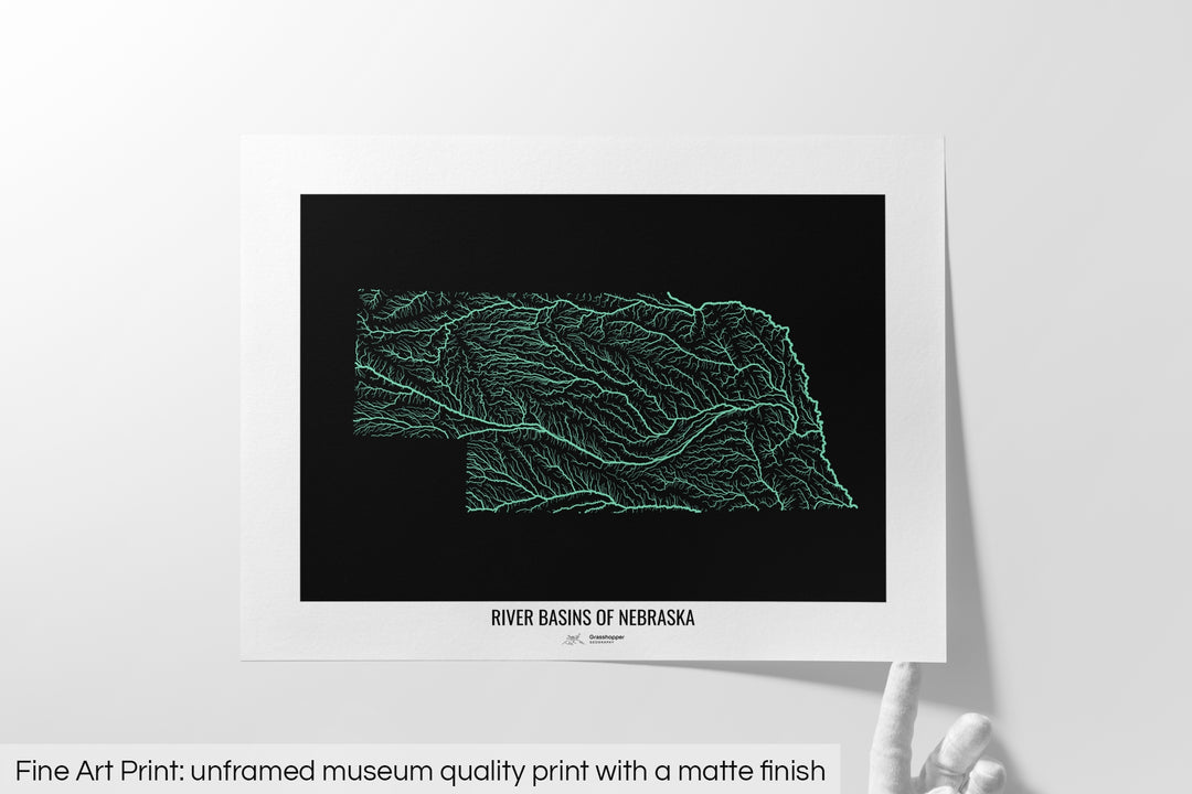 Unframed fine art print of a colourful map with a thick white mat. The title of the map and the Grasshopper Geography logo is printed on the mat, below the image. The map print lies flat on a white surface, a hand holding up one of the corners. The bottom text reads: Fine art print - unframed museum quality print with a matte finish.