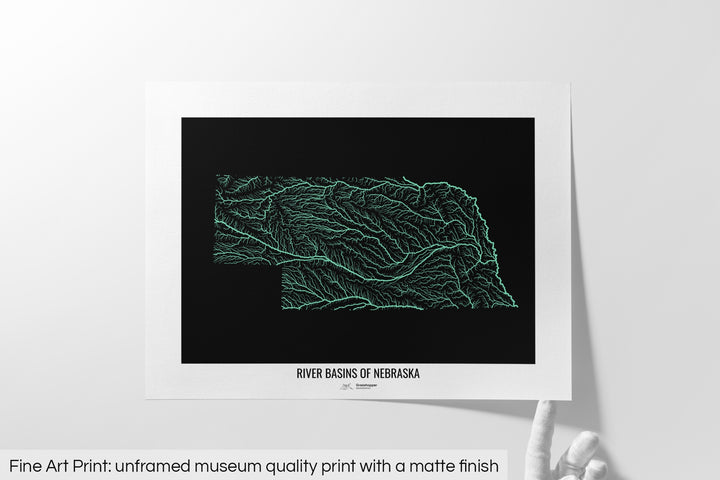 Unframed fine art print of a colourful map with a thick white mat. The title of the map and the Grasshopper Geography logo is printed on the mat, below the image. The map print lies flat on a white surface, a hand holding up one of the corners. The bottom text reads: Fine art print - unframed museum quality print with a matte finish.