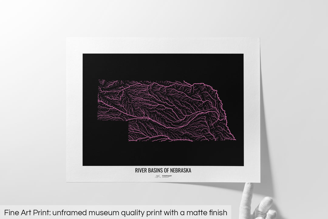 Unframed fine art print of a colourful map with a thick white mat. The title of the map and the Grasshopper Geography logo is printed on the mat, below the image. The map print lies flat on a white surface, a hand holding up one of the corners. The bottom text reads: Fine art print - unframed museum quality print with a matte finish.