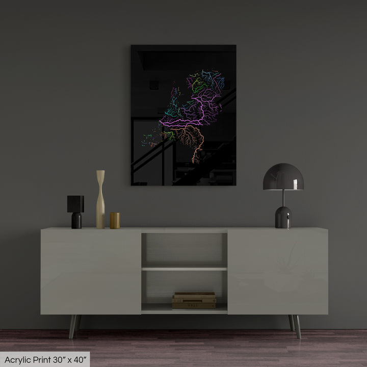 A colourful Grasshopper Geography map, home decor hanging on a grey wall in a living room. The map is printed on an acrylic panel and hangs above a modern low storage cabinet.