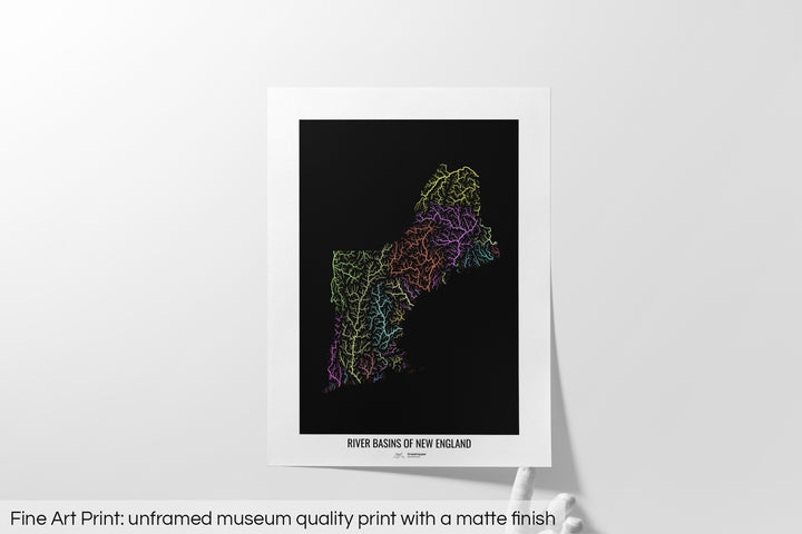 Unframed fine art print of a colourful map with a thick white mat. The title of the map and the Grasshopper Geography logo is printed on the mat, below the image. The map print lies flat on a white surface, a hand holding up one of the corners. The bottom text reads: Fine art print - unframed museum quality print with a matte finish.