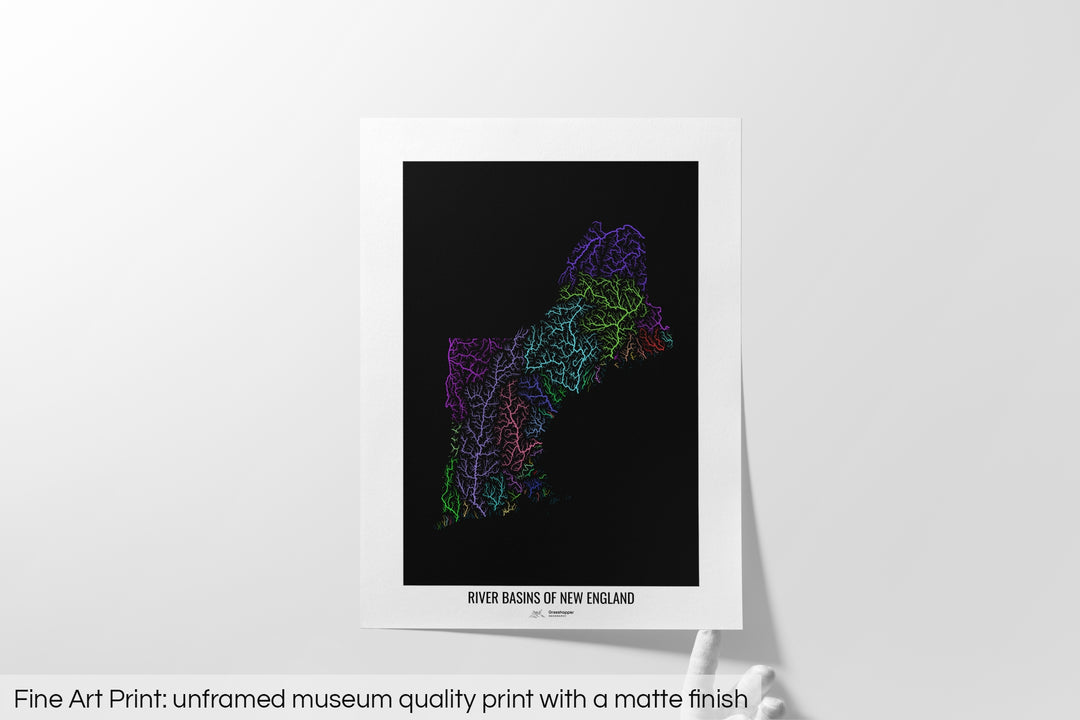 Unframed fine art print of a colourful map with a thick white mat. The title of the map and the Grasshopper Geography logo is printed on the mat, below the image. The map print lies flat on a white surface, a hand holding up one of the corners. The bottom text reads: Fine art print - unframed museum quality print with a matte finish.
