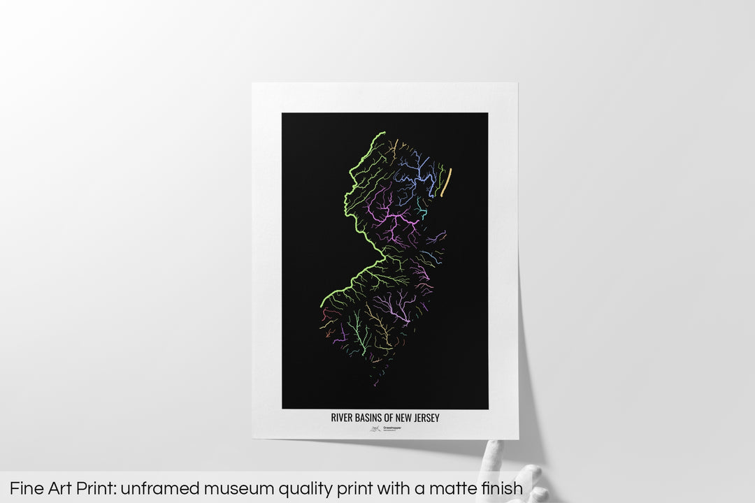 Unframed fine art print of a colourful map with a thick white mat. The title of the map and the Grasshopper Geography logo is printed on the mat, below the image. The map print lies flat on a white surface, a hand holding up one of the corners. The bottom text reads: Fine art print - unframed museum quality print with a matte finish.