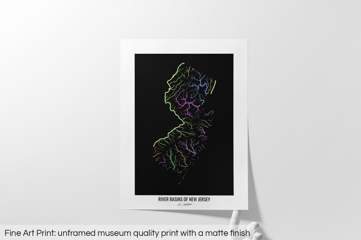 Unframed fine art print of a colourful map with a thick white mat. The title of the map and the Grasshopper Geography logo is printed on the mat, below the image. The map print lies flat on a white surface, a hand holding up one of the corners. The bottom text reads: Fine art print - unframed museum quality print with a matte finish.
