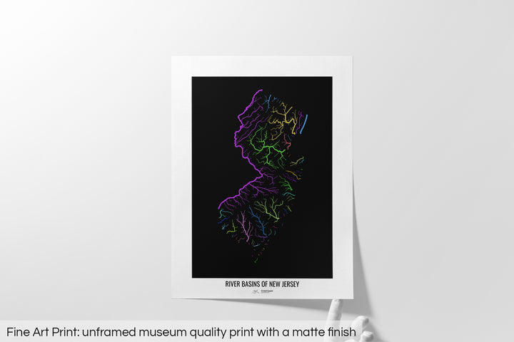 Unframed fine art print of a colourful map with a thick white mat. The title of the map and the Grasshopper Geography logo is printed on the mat, below the image. The map print lies flat on a white surface, a hand holding up one of the corners. The bottom text reads: Fine art print - unframed museum quality print with a matte finish.