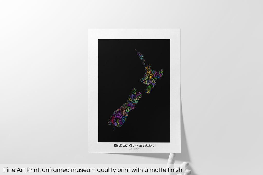 Unframed fine art print of a colourful map with a thick white mat. The title of the map and the Grasshopper Geography logo is printed on the mat, below the image. The map print lies flat on a white surface, a hand holding up one of the corners. The bottom text reads: Fine art print - unframed museum quality print with a matte finish.