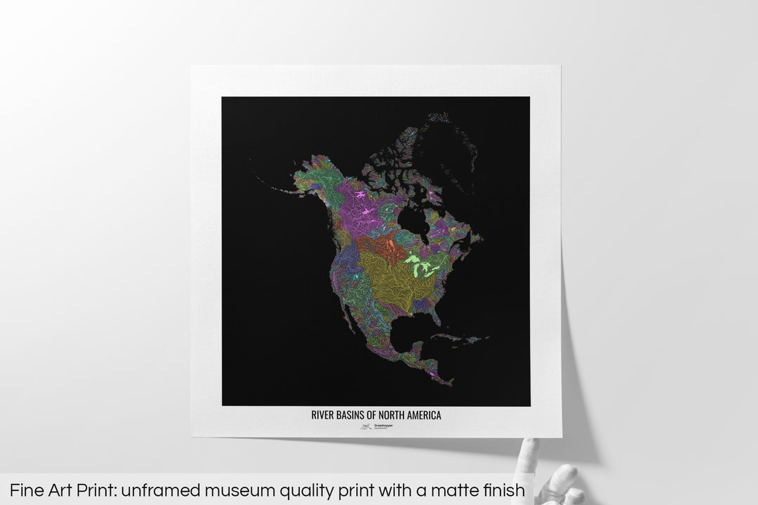 Unframed fine art print of a colourful map with a thick white mat. The title of the map and the Grasshopper Geography logo is printed on the mat, below the image. The map print lies flat on a white surface, a hand holding up one of the corners. The bottom text reads: Fine art print - unframed museum quality print with a matte finish.