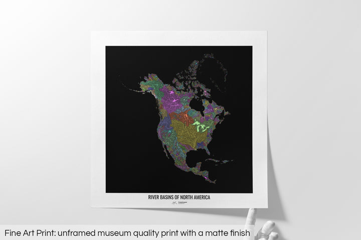 Unframed fine art print of a colourful map with a thick white mat. The title of the map and the Grasshopper Geography logo is printed on the mat, below the image. The map print lies flat on a white surface, a hand holding up one of the corners. The bottom text reads: Fine art print - unframed museum quality print with a matte finish.