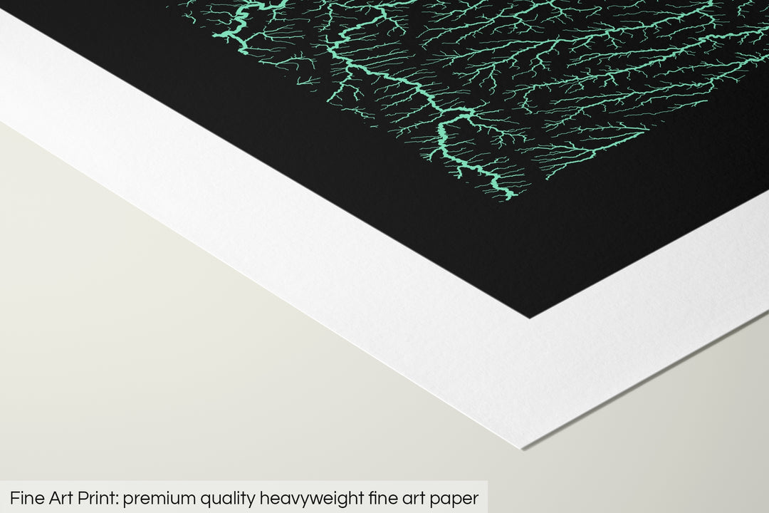 Closeup of a fine art print's corner lying on a flat surface, the details of a Grasshopper Geography map is visible. The text at the bottom reads: Fine art print - premium quality heavyweight fine art paper.