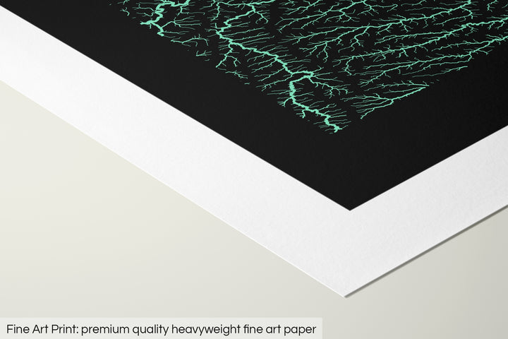 Closeup of a fine art print's corner lying on a flat surface, the details of a Grasshopper Geography map is visible. The text at the bottom reads: Fine art print - premium quality heavyweight fine art paper.