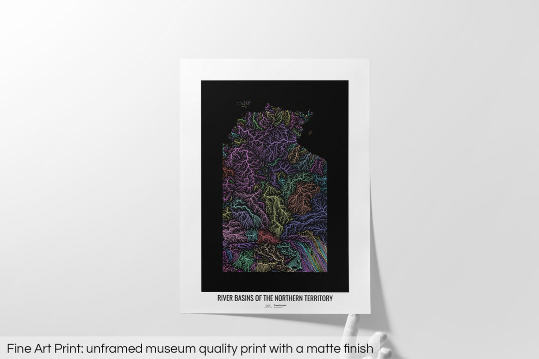 Unframed fine art print of a colourful map with a thick white mat. The title of the map and the Grasshopper Geography logo is printed on the mat, below the image. The map print lies flat on a white surface, a hand holding up one of the corners. The bottom text reads: Fine art print - unframed museum quality print with a matte finish.
