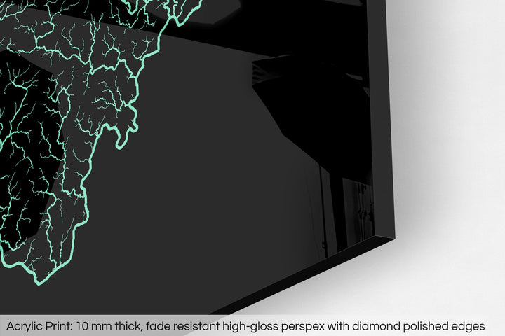 Closeup of an acrylic panel's corner, the details of a Grasshopper Geography map is visible. The text at the bottom reads: Acrylic print - 10 mm thick, fade reistant high-gloss perspex with diamond polished edges.