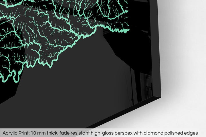 Closeup of an acrylic panel's corner, the details of a Grasshopper Geography map is visible. The text at the bottom reads: Acrylic print - 10 mm thick, fade reistant high-gloss perspex with diamond polished edges.
