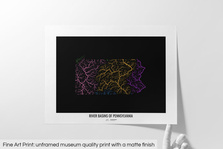 Unframed fine art print of a colourful map with a thick white mat. The title of the map and the Grasshopper Geography logo is printed on the mat, below the image. The map print lies flat on a white surface, a hand holding up one of the corners. The bottom text reads: Fine art print - unframed museum quality print with a matte finish.