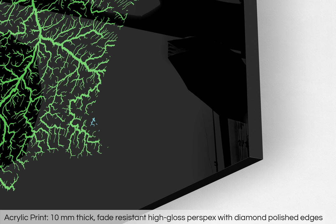Closeup of an acrylic panel's corner, the details of a Grasshopper Geography map is visible. The text at the bottom reads: Acrylic print - 10 mm thick, fade reistant high-gloss perspex with diamond polished edges.