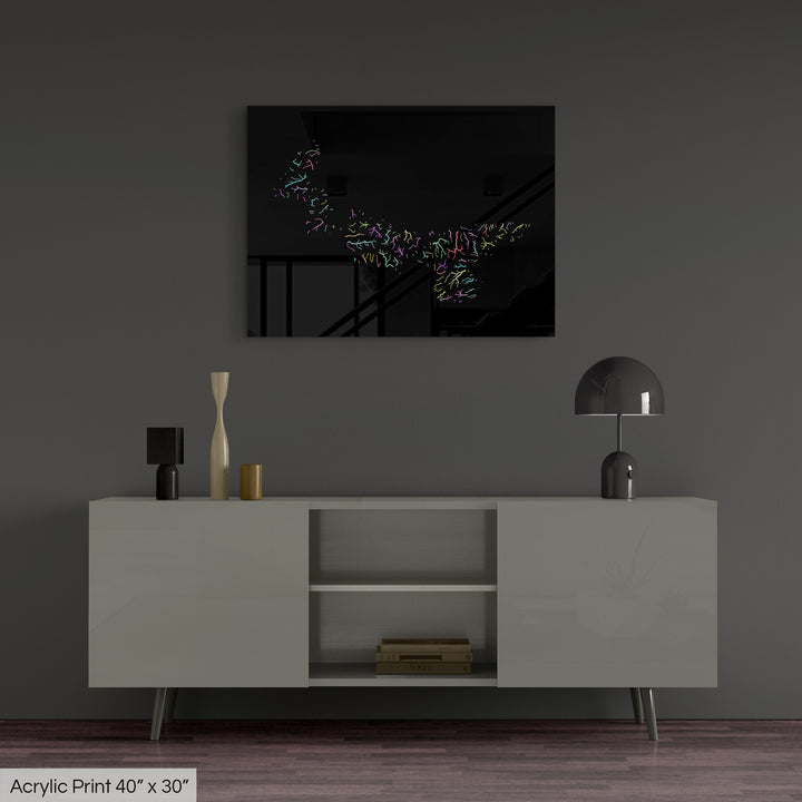 A colourful Grasshopper Geography map, home decor hanging on a grey wall in a living room. The map is printed on an acrylic panel and hangs above a modern low storage cabinet.
