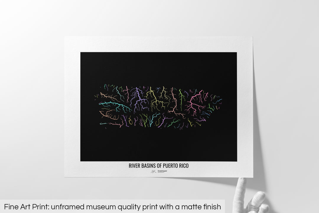 Unframed fine art print of a colourful map with a thick white mat. The title of the map and the Grasshopper Geography logo is printed on the mat, below the image. The map print lies flat on a white surface, a hand holding up one of the corners. The bottom text reads: Fine art print - unframed museum quality print with a matte finish.