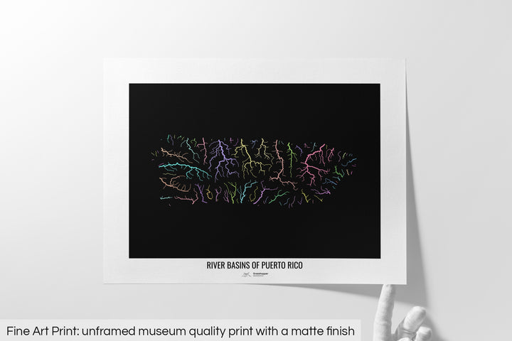Unframed fine art print of a colourful map with a thick white mat. The title of the map and the Grasshopper Geography logo is printed on the mat, below the image. The map print lies flat on a white surface, a hand holding up one of the corners. The bottom text reads: Fine art print - unframed museum quality print with a matte finish.