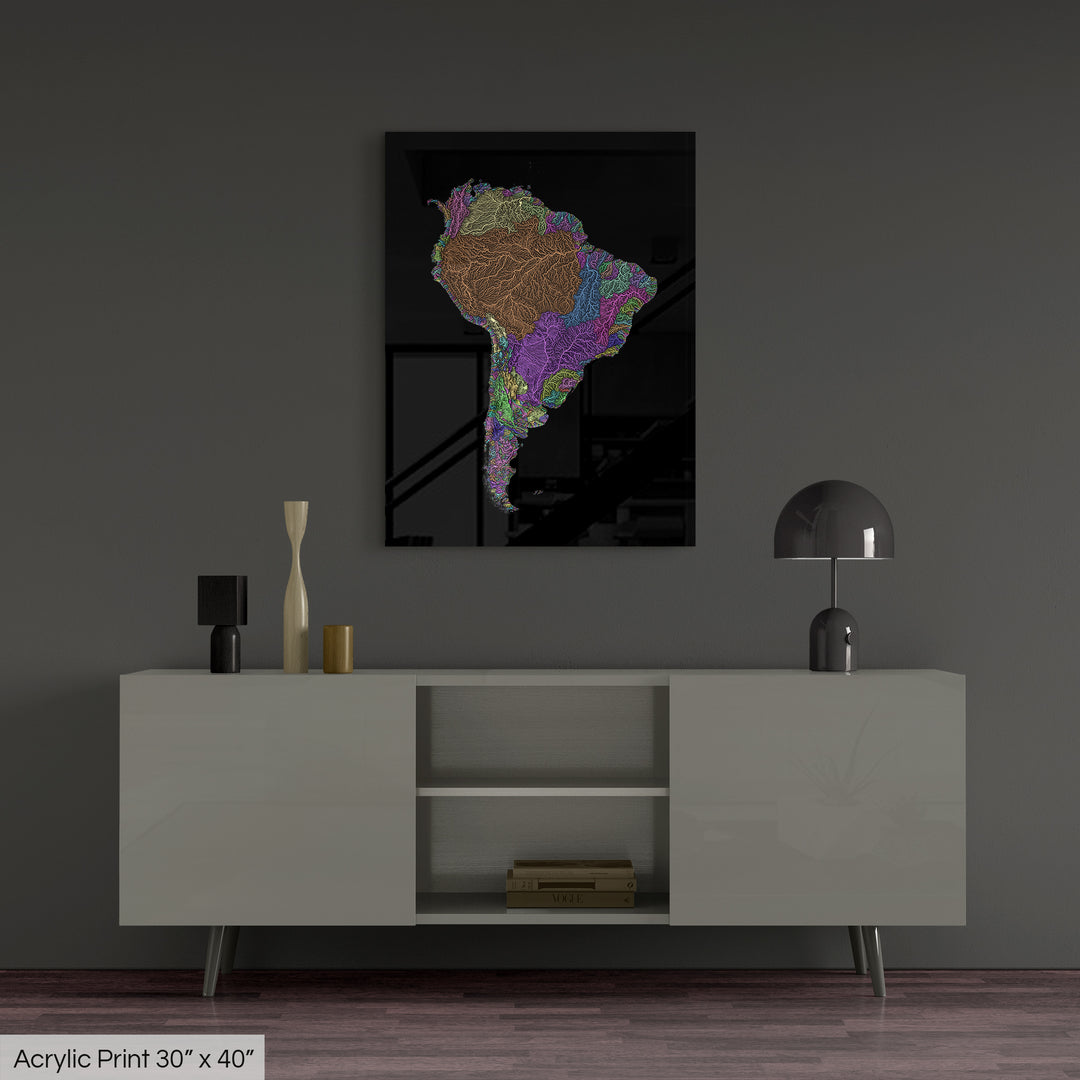 A colourful Grasshopper Geography map, home decor hanging on a grey wall in a living room. The map is printed on an acrylic panel and hangs above a modern low storage cabinet.