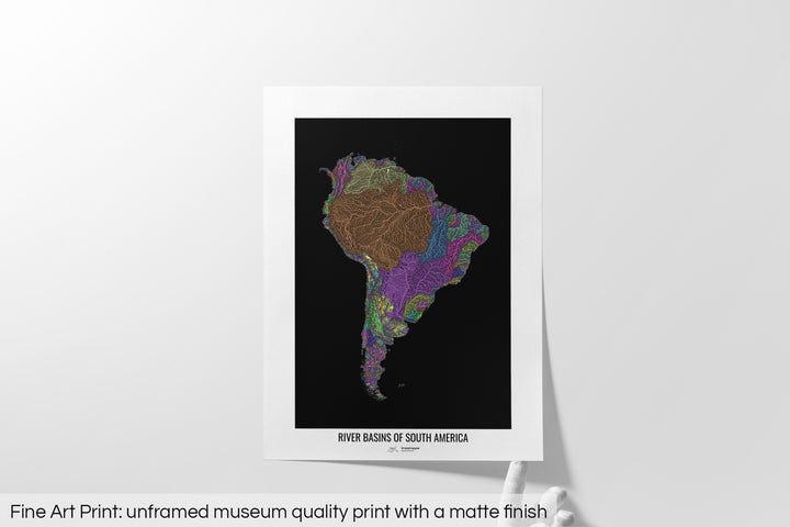 Unframed fine art print of a colourful map with a thick white mat. The title of the map and the Grasshopper Geography logo is printed on the mat, below the image. The map print lies flat on a white surface, a hand holding up one of the corners. The bottom text reads: Fine art print - unframed museum quality print with a matte finish.