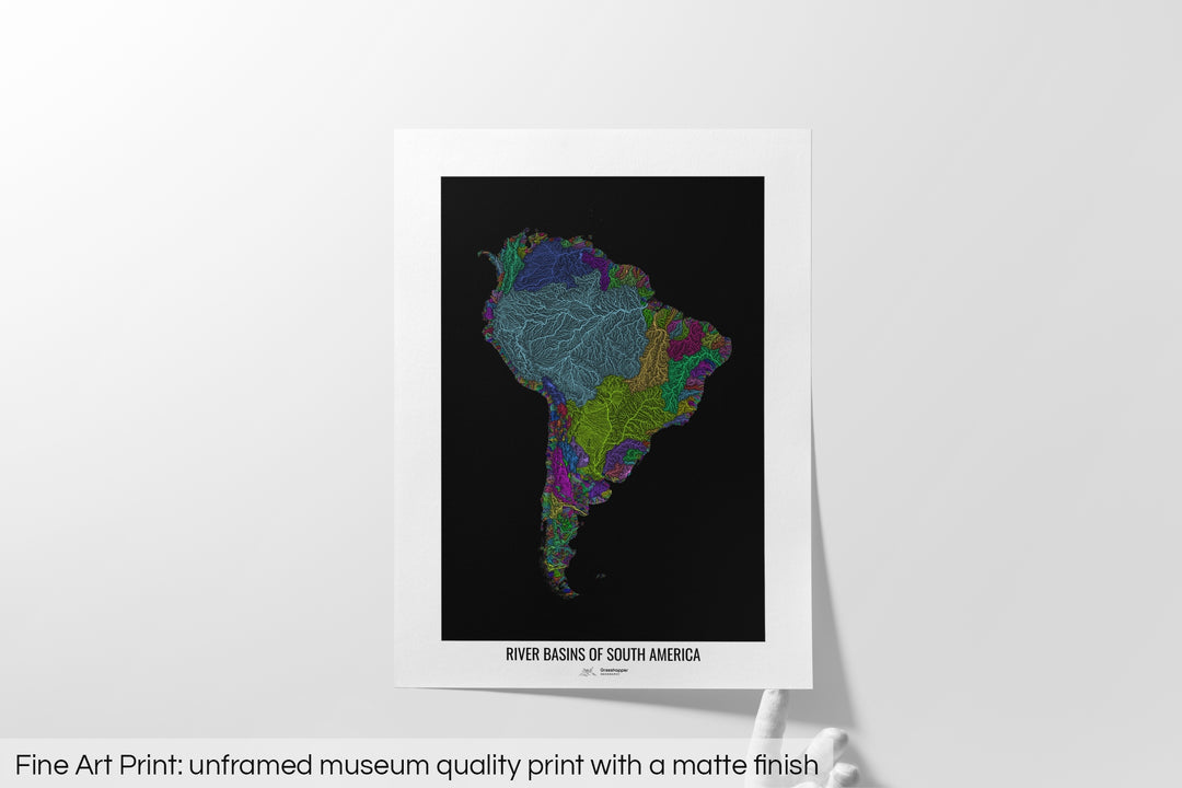 Unframed fine art print of a colourful map with a thick white mat. The title of the map and the Grasshopper Geography logo is printed on the mat, below the image. The map print lies flat on a white surface, a hand holding up one of the corners. The bottom text reads: Fine art print - unframed museum quality print with a matte finish.