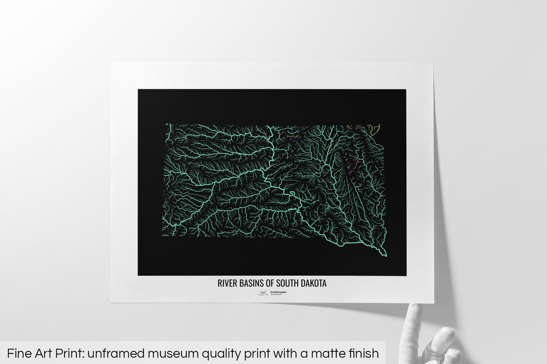 Unframed fine art print of a colourful map with a thick white mat. The title of the map and the Grasshopper Geography logo is printed on the mat, below the image. The map print lies flat on a white surface, a hand holding up one of the corners. The bottom text reads: Fine art print - unframed museum quality print with a matte finish.