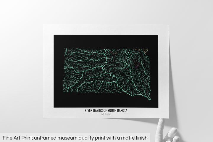 Unframed fine art print of a colourful map with a thick white mat. The title of the map and the Grasshopper Geography logo is printed on the mat, below the image. The map print lies flat on a white surface, a hand holding up one of the corners. The bottom text reads: Fine art print - unframed museum quality print with a matte finish.