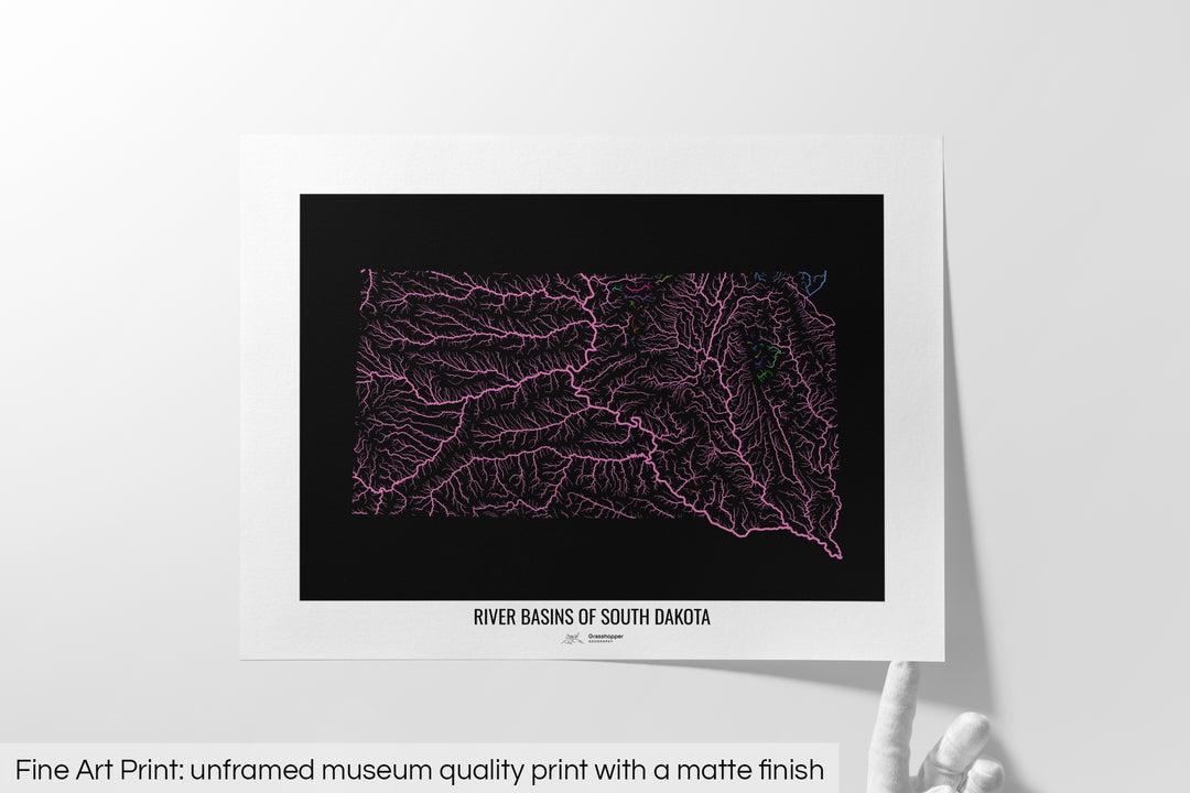 Unframed fine art print of a colourful map with a thick white mat. The title of the map and the Grasshopper Geography logo is printed on the mat, below the image. The map print lies flat on a white surface, a hand holding up one of the corners. The bottom text reads: Fine art print - unframed museum quality print with a matte finish.