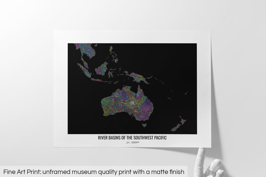 Unframed fine art print of a colourful map with a thick white mat. The title of the map and the Grasshopper Geography logo is printed on the mat, below the image. The map print lies flat on a white surface, a hand holding up one of the corners. The bottom text reads: Fine art print - unframed museum quality print with a matte finish.