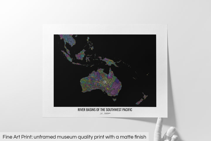 Unframed fine art print of a colourful map with a thick white mat. The title of the map and the Grasshopper Geography logo is printed on the mat, below the image. The map print lies flat on a white surface, a hand holding up one of the corners. The bottom text reads: Fine art print - unframed museum quality print with a matte finish.