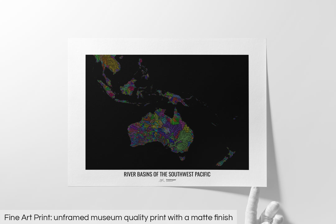 Unframed fine art print of a colourful map with a thick white mat. The title of the map and the Grasshopper Geography logo is printed on the mat, below the image. The map print lies flat on a white surface, a hand holding up one of the corners. The bottom text reads: Fine art print - unframed museum quality print with a matte finish.