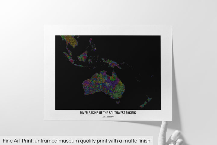 Unframed fine art print of a colourful map with a thick white mat. The title of the map and the Grasshopper Geography logo is printed on the mat, below the image. The map print lies flat on a white surface, a hand holding up one of the corners. The bottom text reads: Fine art print - unframed museum quality print with a matte finish.