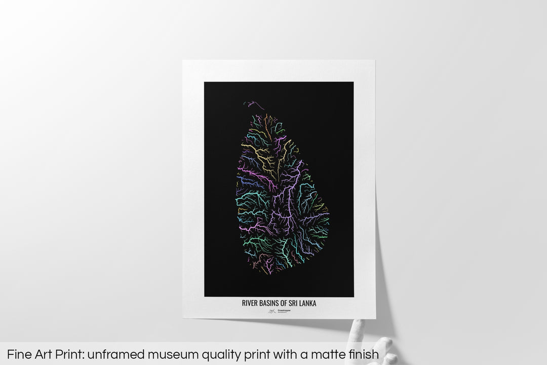Unframed fine art print of a colourful map with a thick white mat. The title of the map and the Grasshopper Geography logo is printed on the mat, below the image. The map print lies flat on a white surface, a hand holding up one of the corners. The bottom text reads: Fine art print - unframed museum quality print with a matte finish.