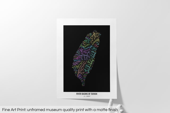 Unframed fine art print of a colourful map with a thick white mat. The title of the map and the Grasshopper Geography logo is printed on the mat, below the image. The map print lies flat on a white surface, a hand holding up one of the corners. The bottom text reads: Fine art print - unframed museum quality print with a matte finish.