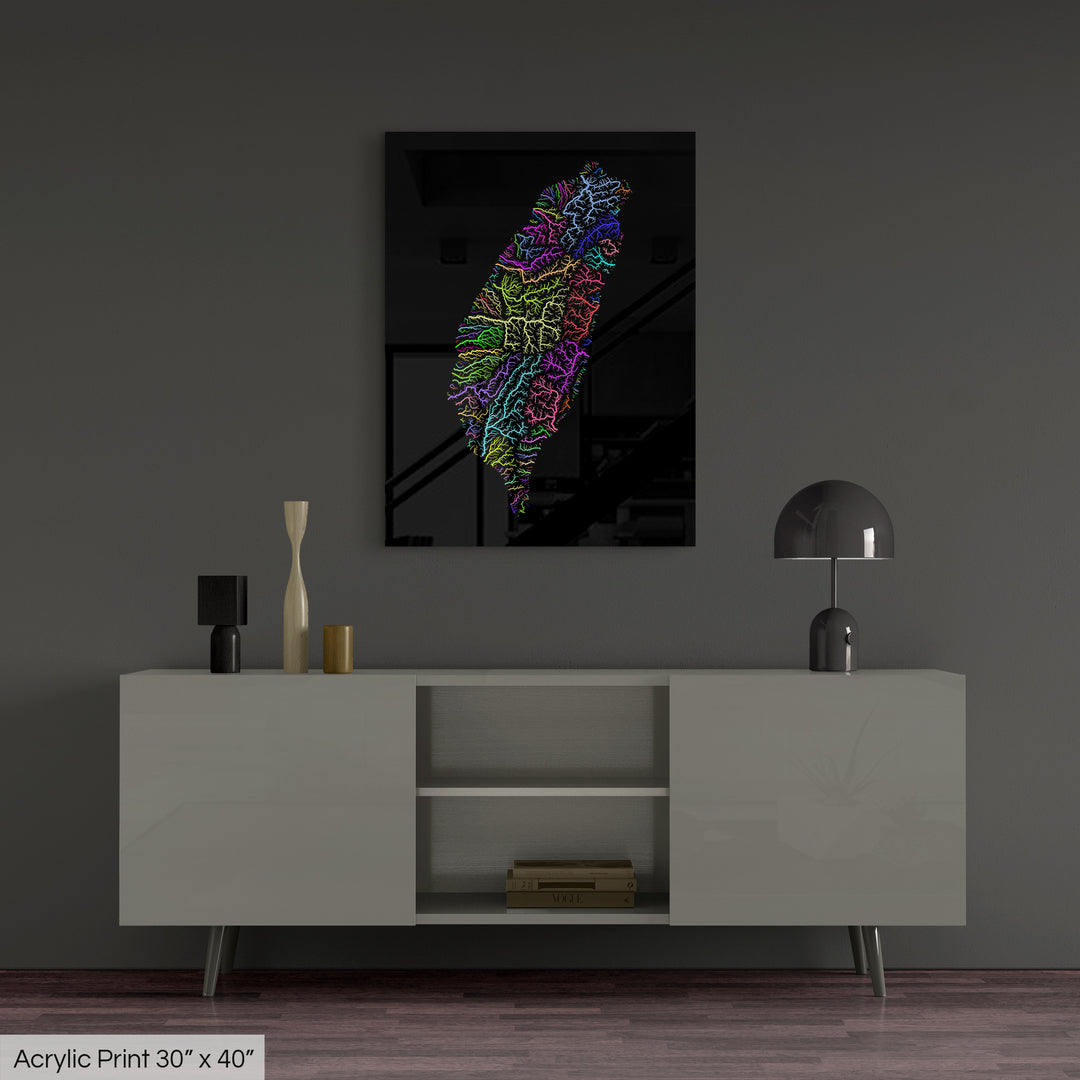 A colourful Grasshopper Geography map, home decor hanging on a grey wall in a living room. The map is printed on an acrylic panel and hangs above a modern low storage cabinet.