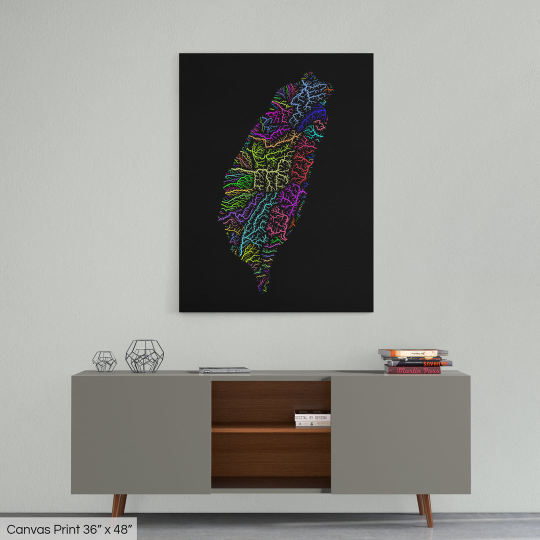 A colourful Grasshopper Geography map home decor in a living room, on a light grey wall. The map is printed on canvas and hangs above a modern low storage cabinet.