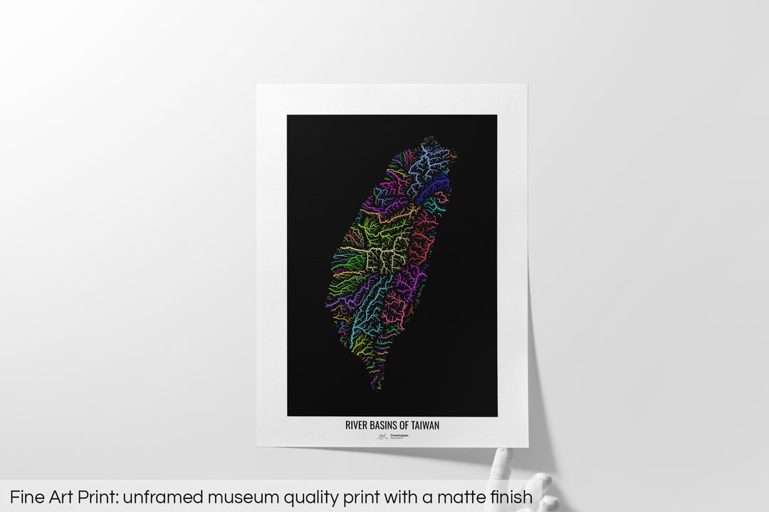 Unframed fine art print of a colourful map with a thick white mat. The title of the map and the Grasshopper Geography logo is printed on the mat, below the image. The map print lies flat on a white surface, a hand holding up one of the corners. The bottom text reads: Fine art print - unframed museum quality print with a matte finish.