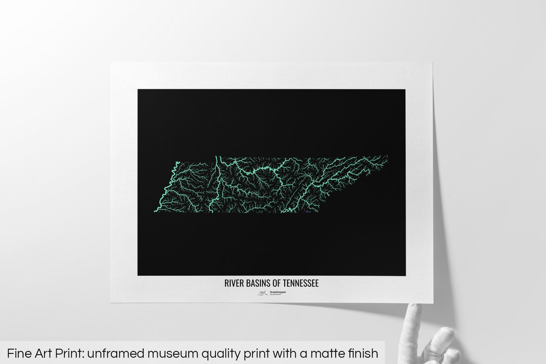 Unframed fine art print of a colourful map with a thick white mat. The title of the map and the Grasshopper Geography logo is printed on the mat, below the image. The map print lies flat on a white surface, a hand holding up one of the corners. The bottom text reads: Fine art print - unframed museum quality print with a matte finish.